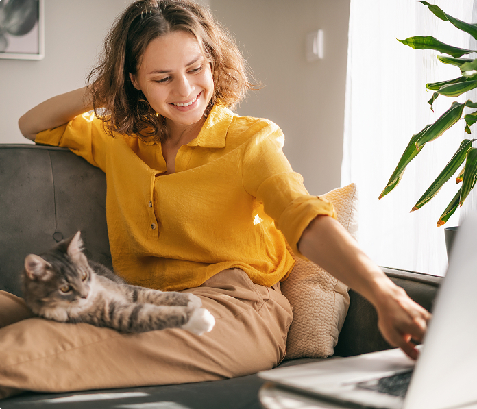 Woman working on laptop from couch