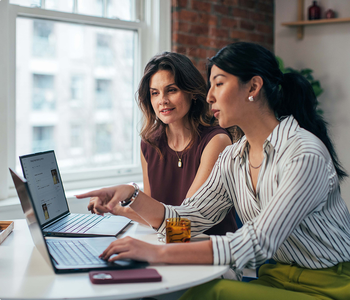 Two women working on computers